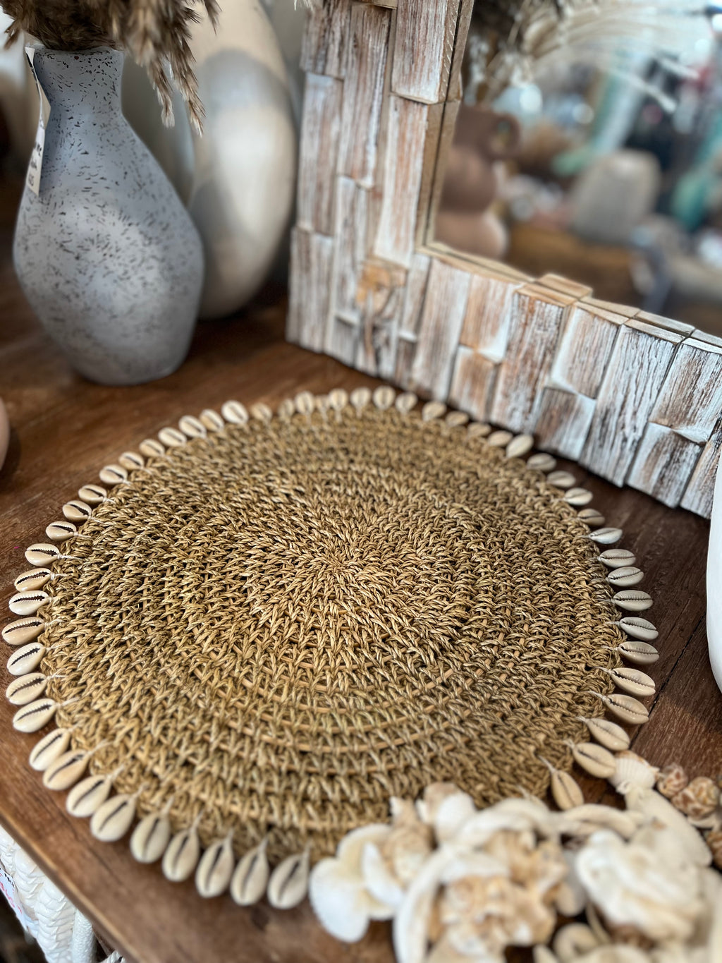 Woven placemat with shell fringe. 34cm
