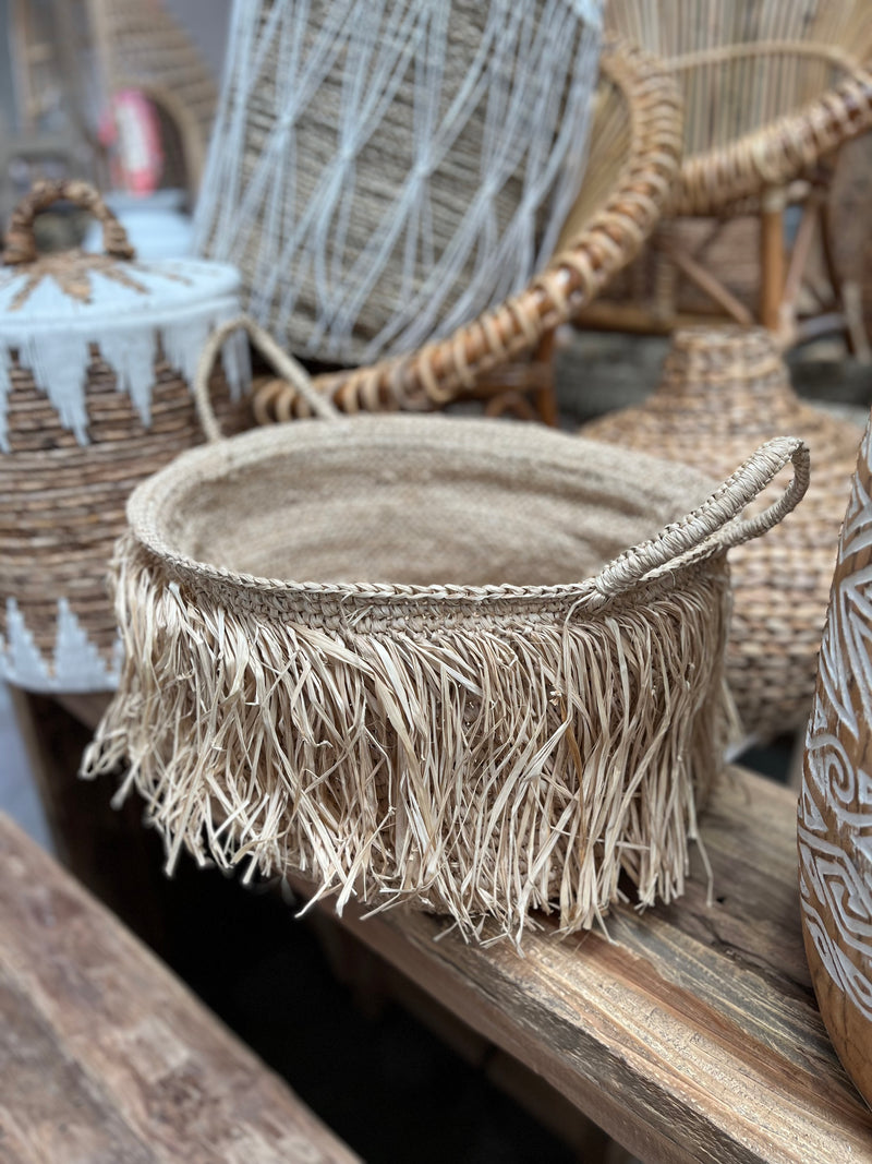 Woven basket with raffia trim detail
