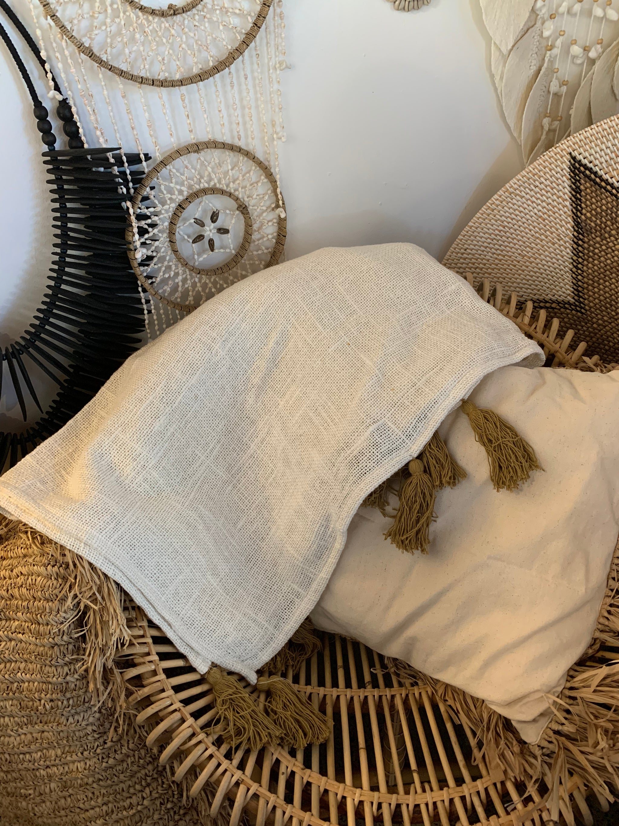 Natural throw with brown tassels