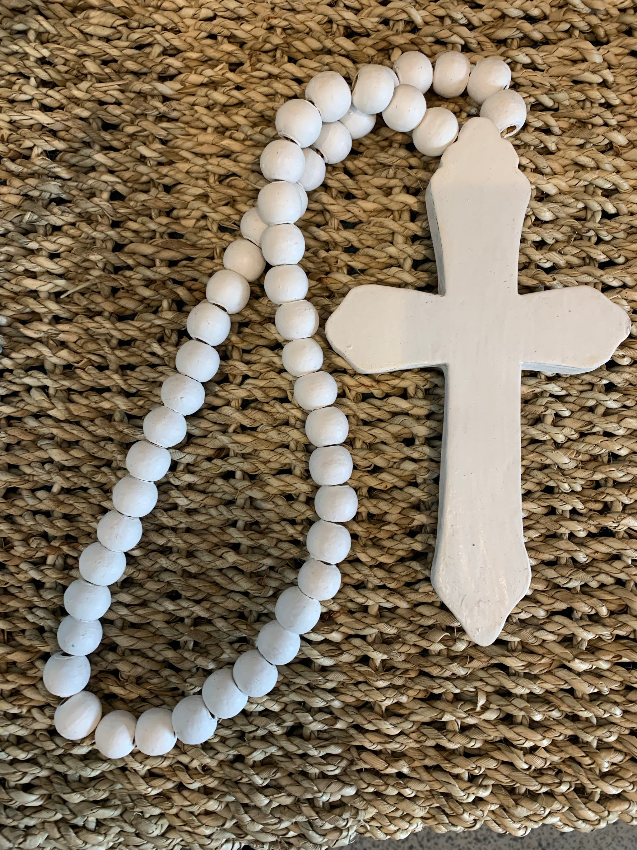 Rustic white timber cross with white beads.