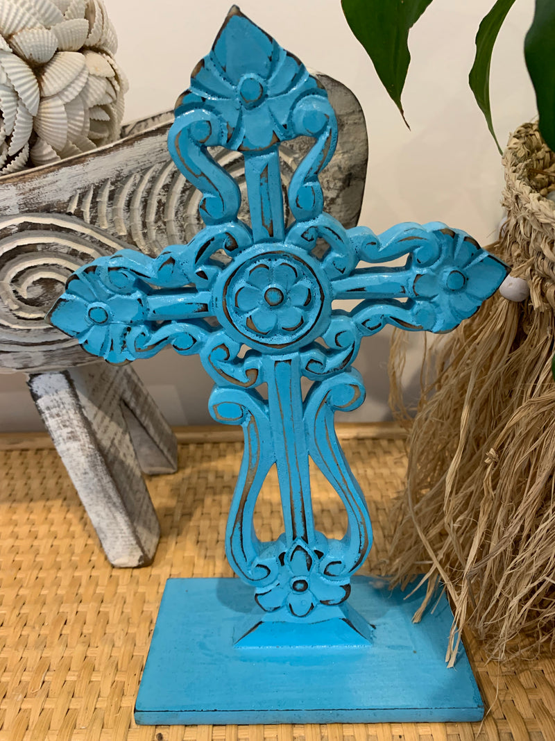Blue carved cross on stand.